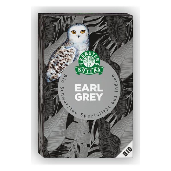 Verpackung von Bio-Earl Grey Tee mit einem Eulen-Motiv und tropischen Blättern auf schwarzem Hintergrund.