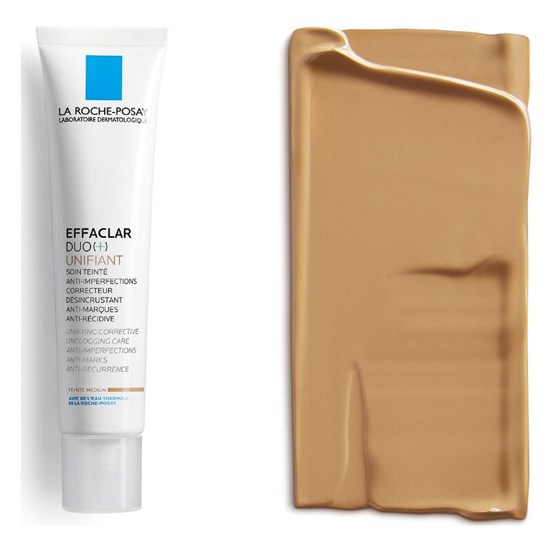 Ein Pflegeprodukt in einer weißen Tube mit blauer Markierung und einer cremigen Farbe daneben.