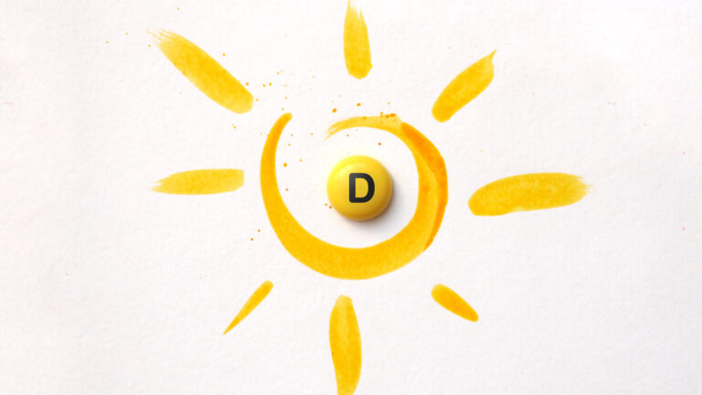 Gelbe Malerei eines Sonnenmotivs mit einer runden, gelben Pille mit dem Buchstaben D in der Mitte.